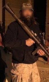 A man holding an old rifle in his hands.